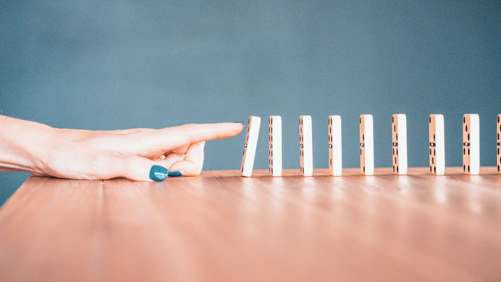 A pair of hands holding interlocking white and blue plastic building blocks