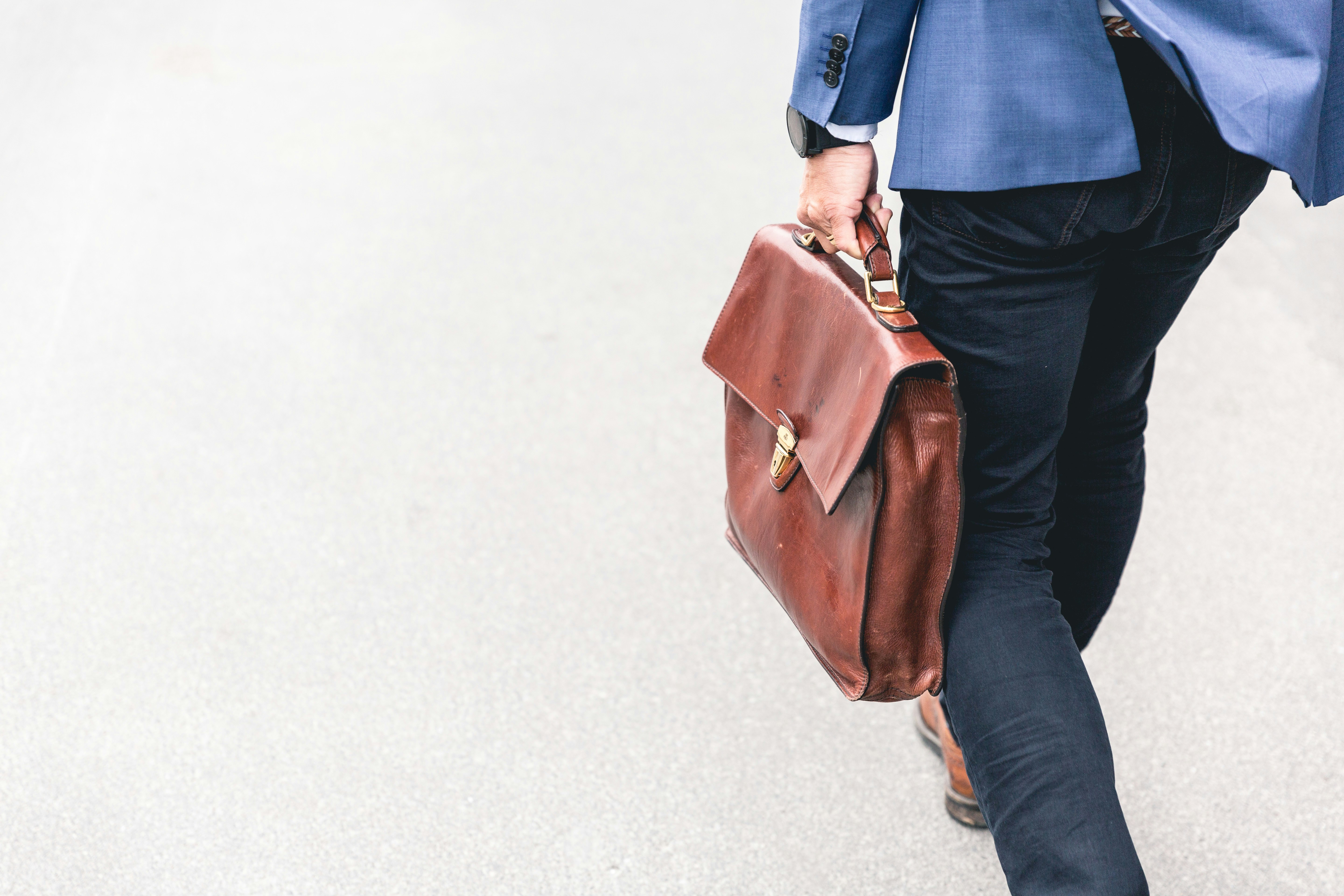 Person walking with leather bag - networking concept