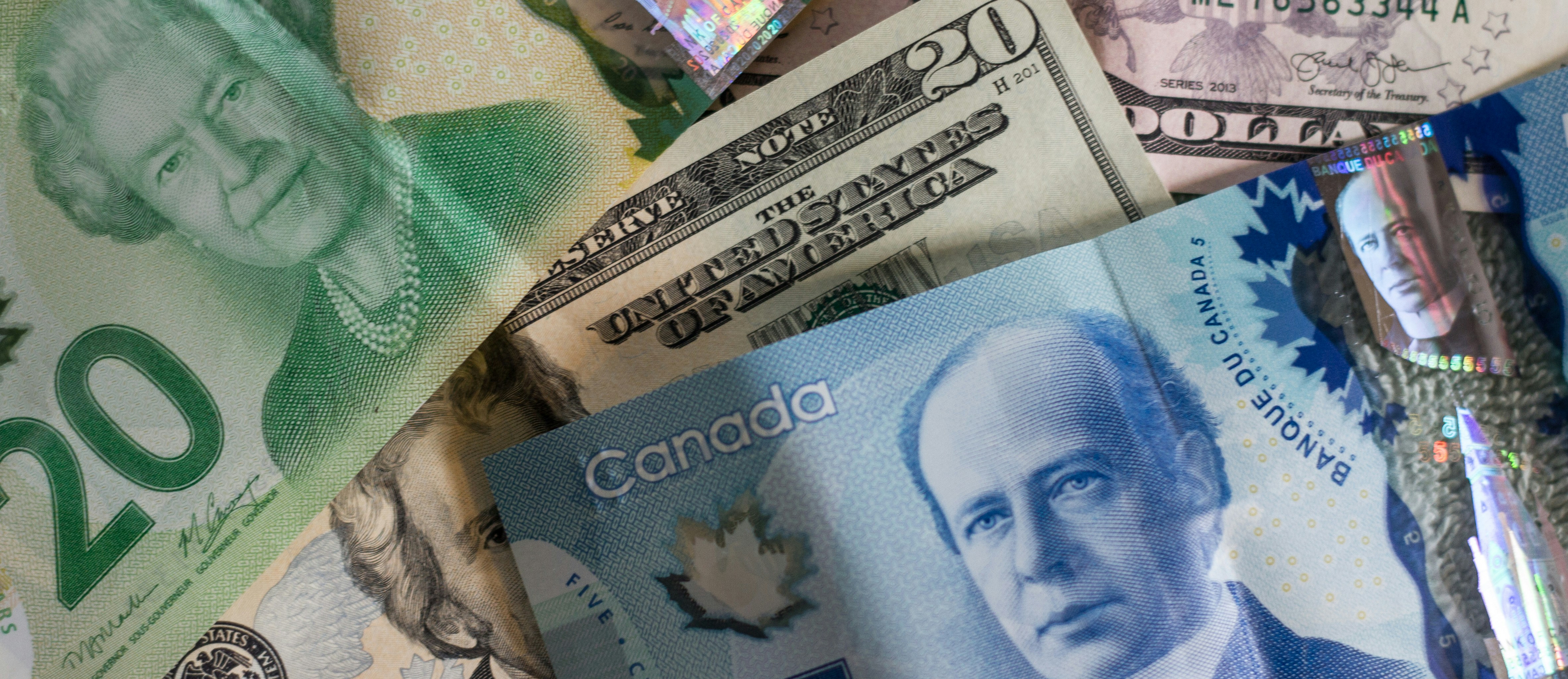 Canadian and US currency bills spread out