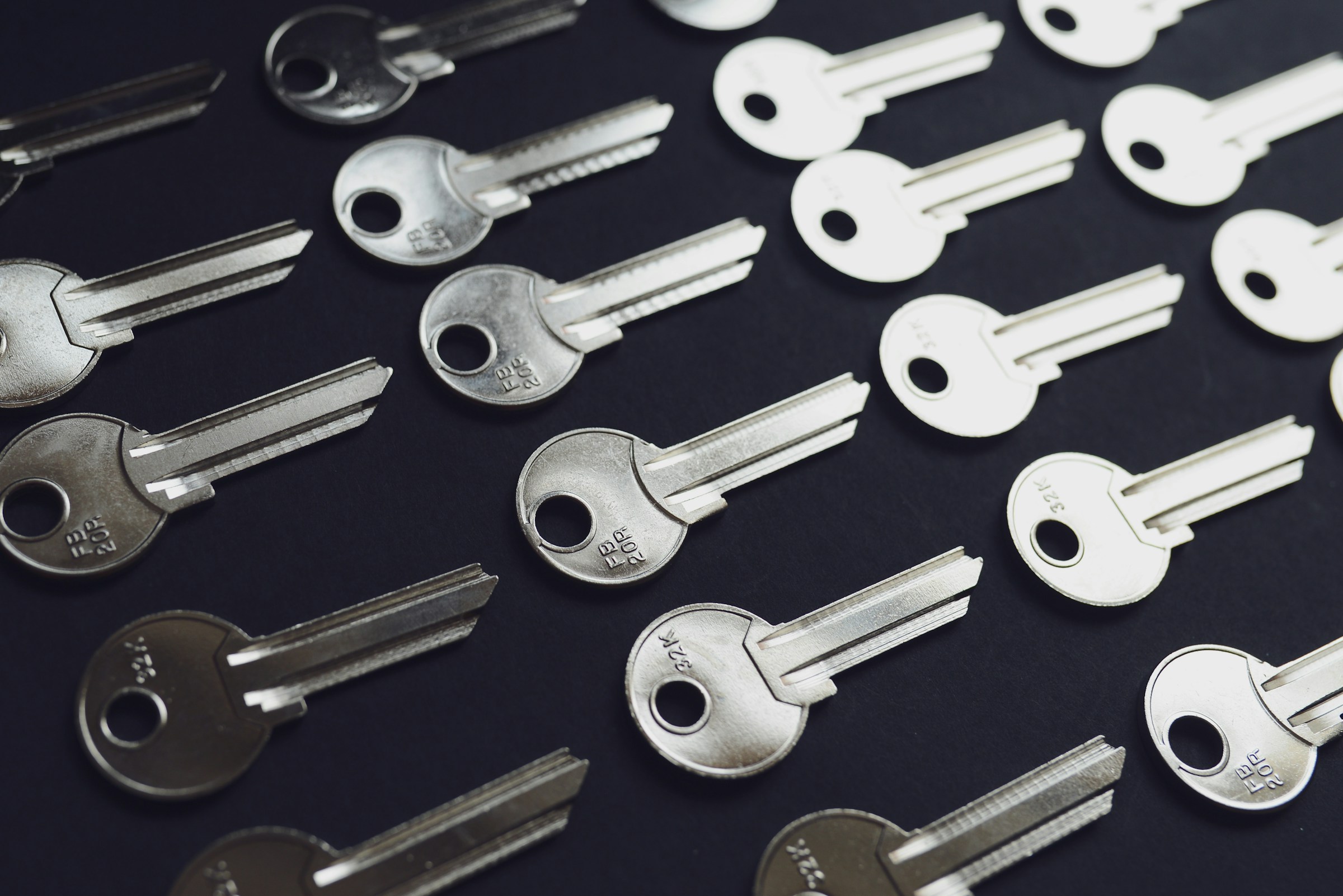 Silver keys arranged in rows on a dark surface