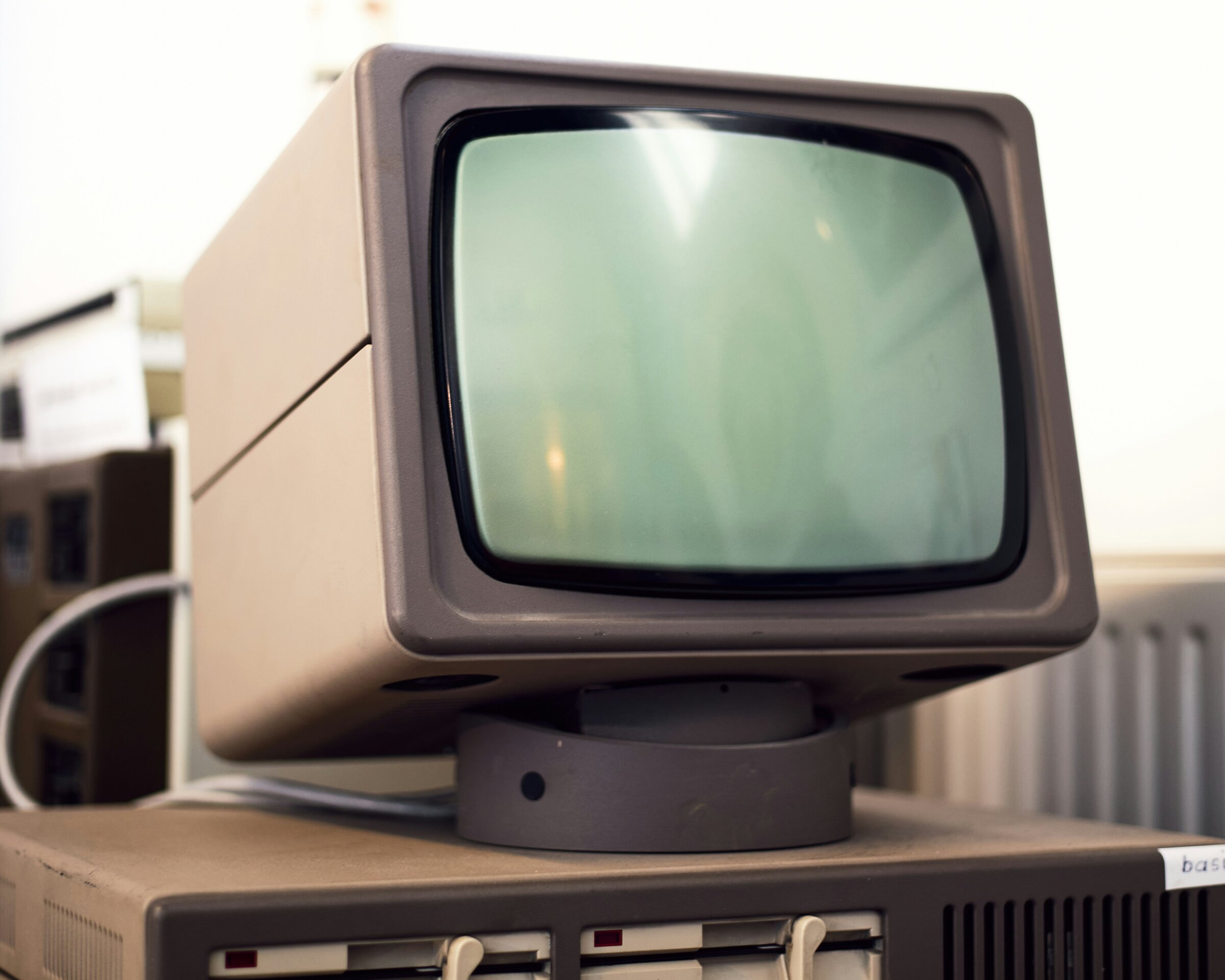 A beige Robotron 1715 computer with a small CRT monitor sitting on top of its twin floppy drive unit