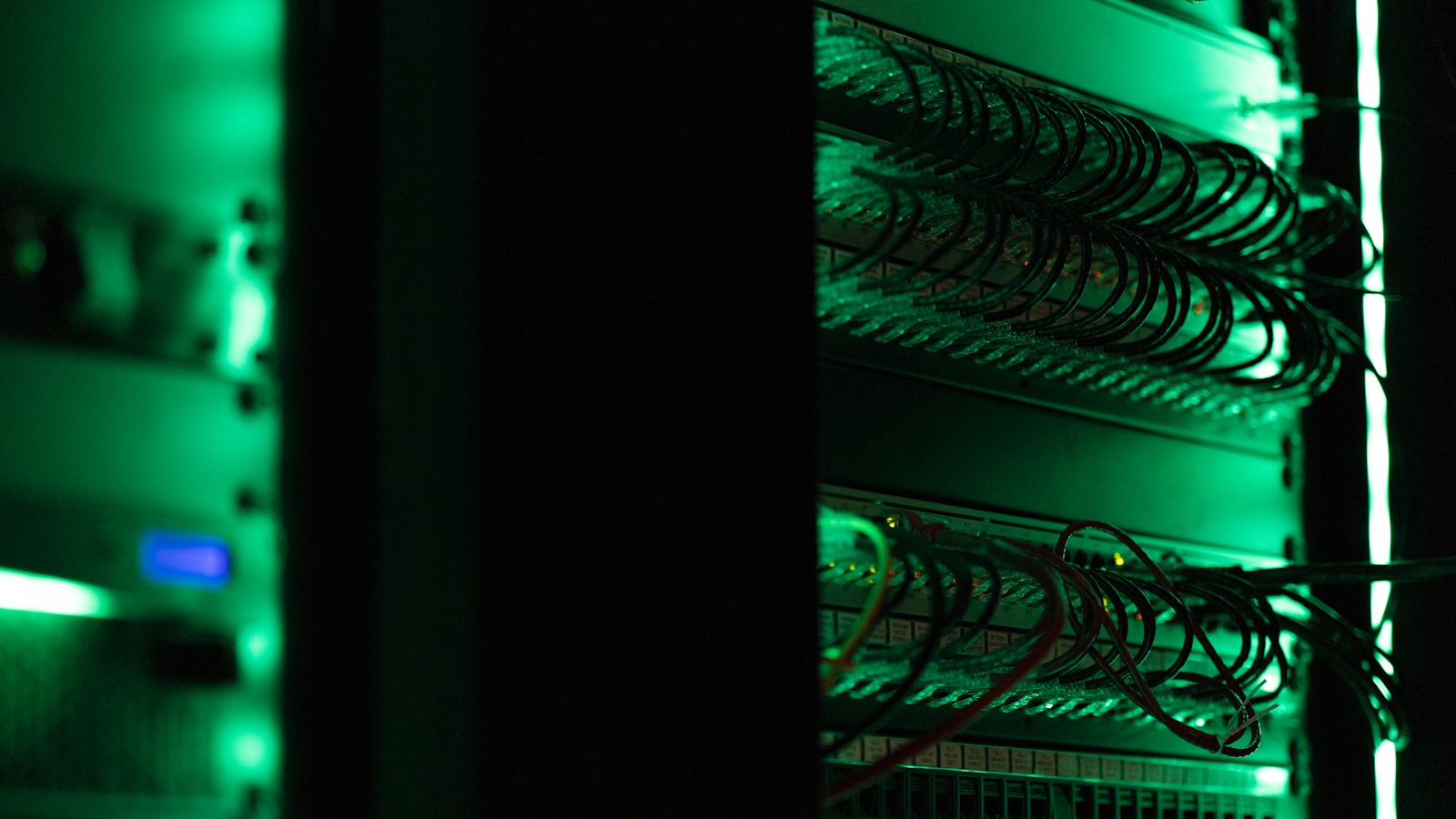 A rack of electronic equipment glowing in a dark room